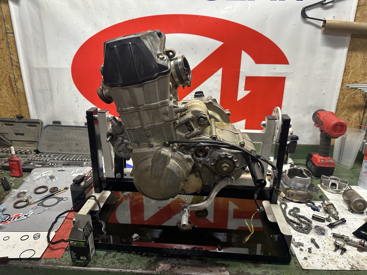 Dirt bike engine mounted on a work stand during a rebuild