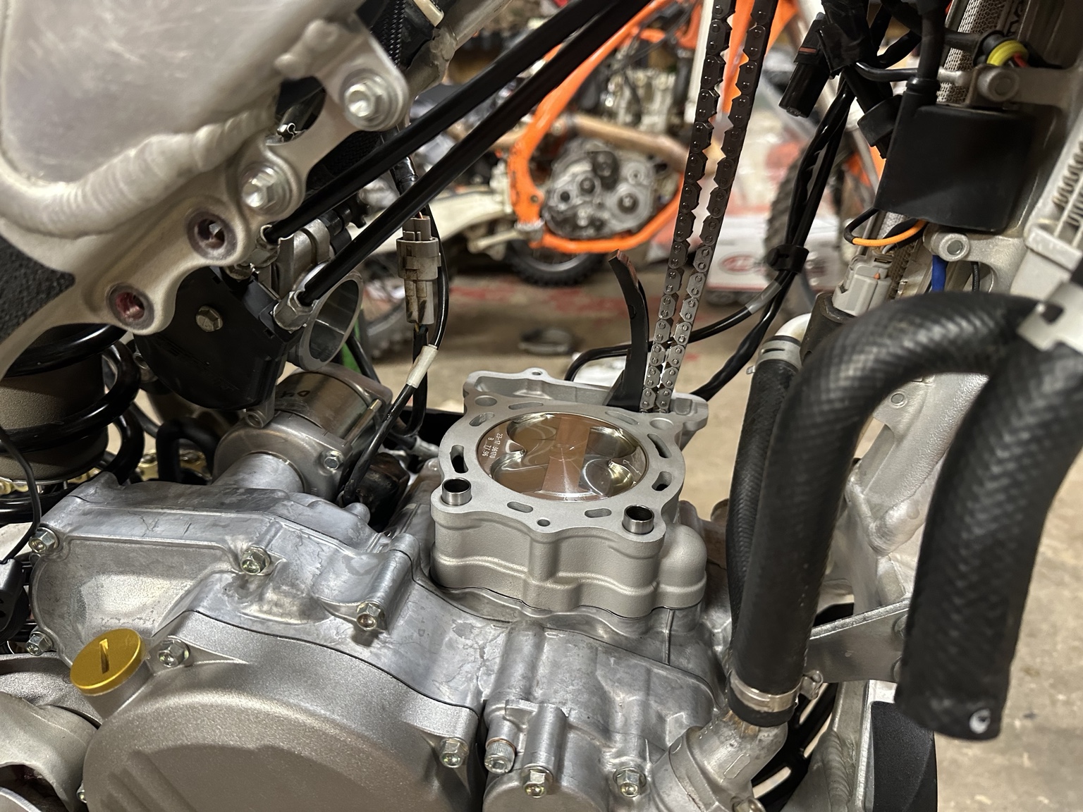 Fresh piston and cylinder installed during a dirt bike top-end rebuild